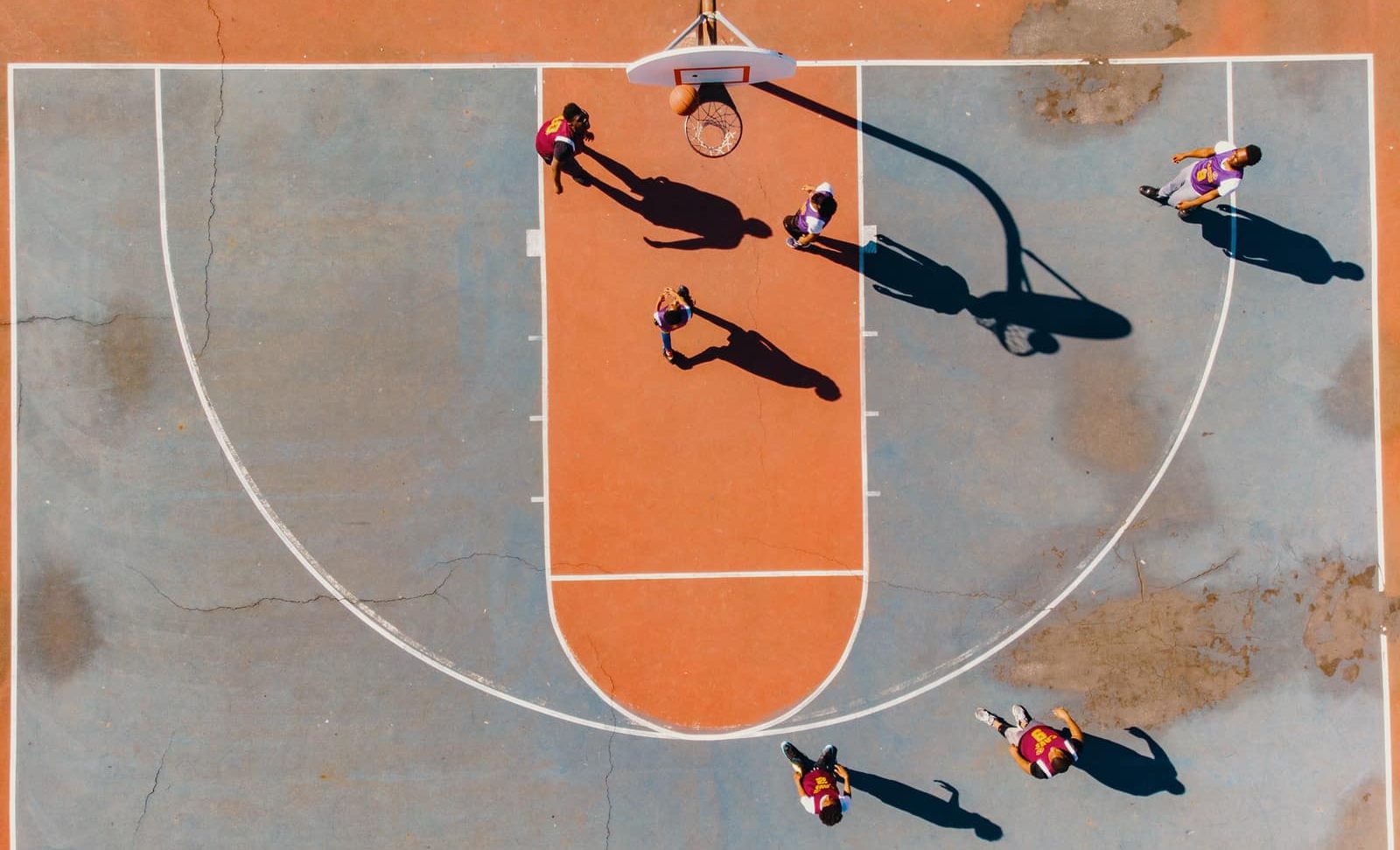What does a bonus mean in basketball (bonus situation/penalty situation)? aerial photography of men playing basketball
