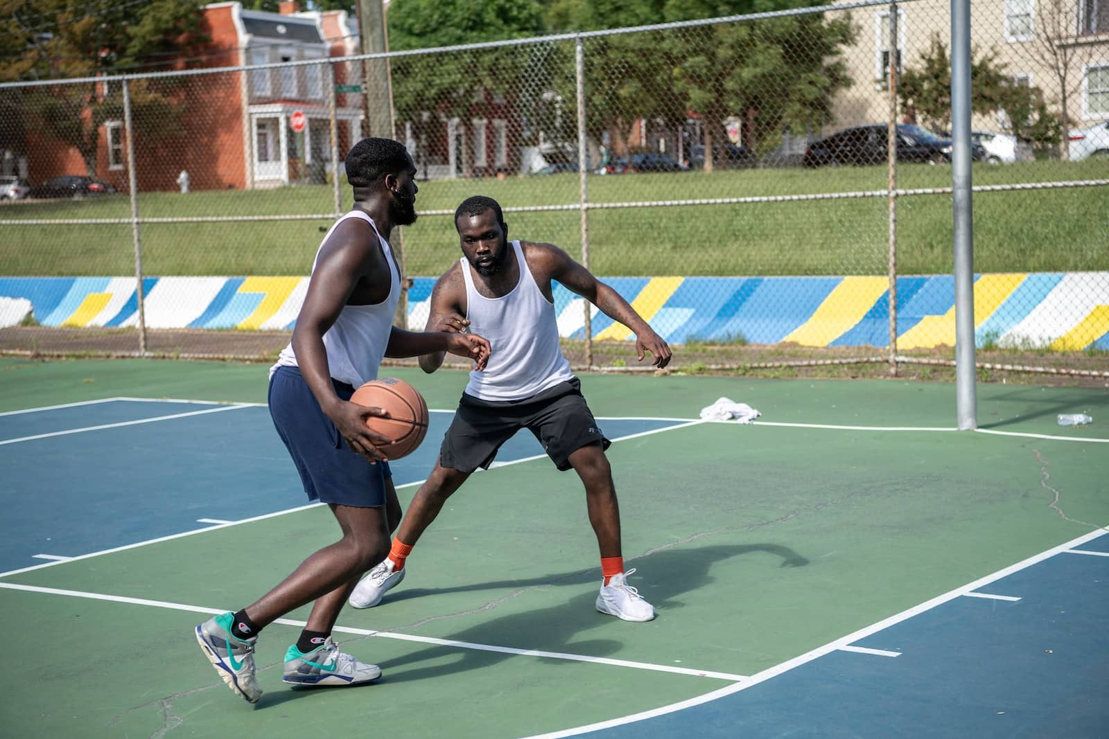 man in white tank top playing basketball