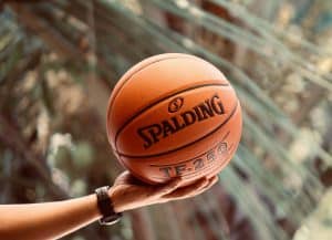 a person holding a basketball in their hand