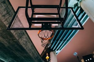 outdoor basketball hoop under gray concrete bridge
